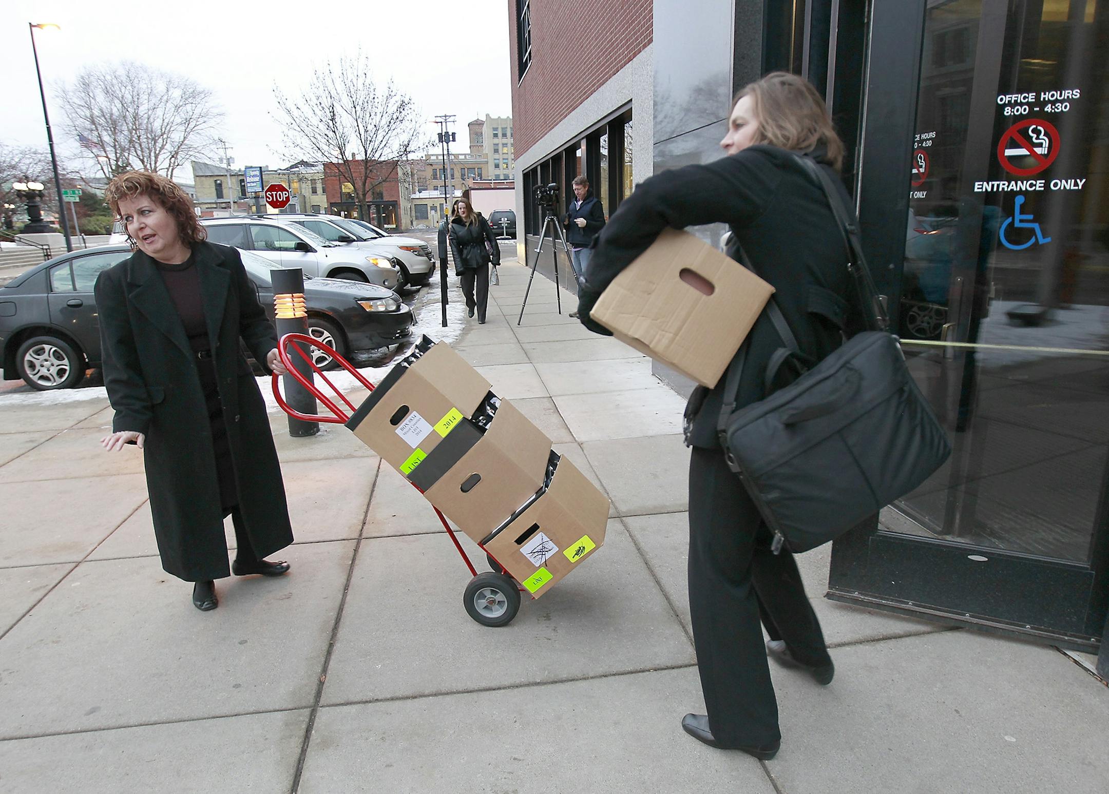 Defense attorney Lauri Traub, left, made her way into the Stearns County District Courthouse for the opening statements in the Brian G. Fitch trial, Tuesday, January 20, 2015. Brian G. Fitch is on trial for killing Officer Scott Patrick last year.