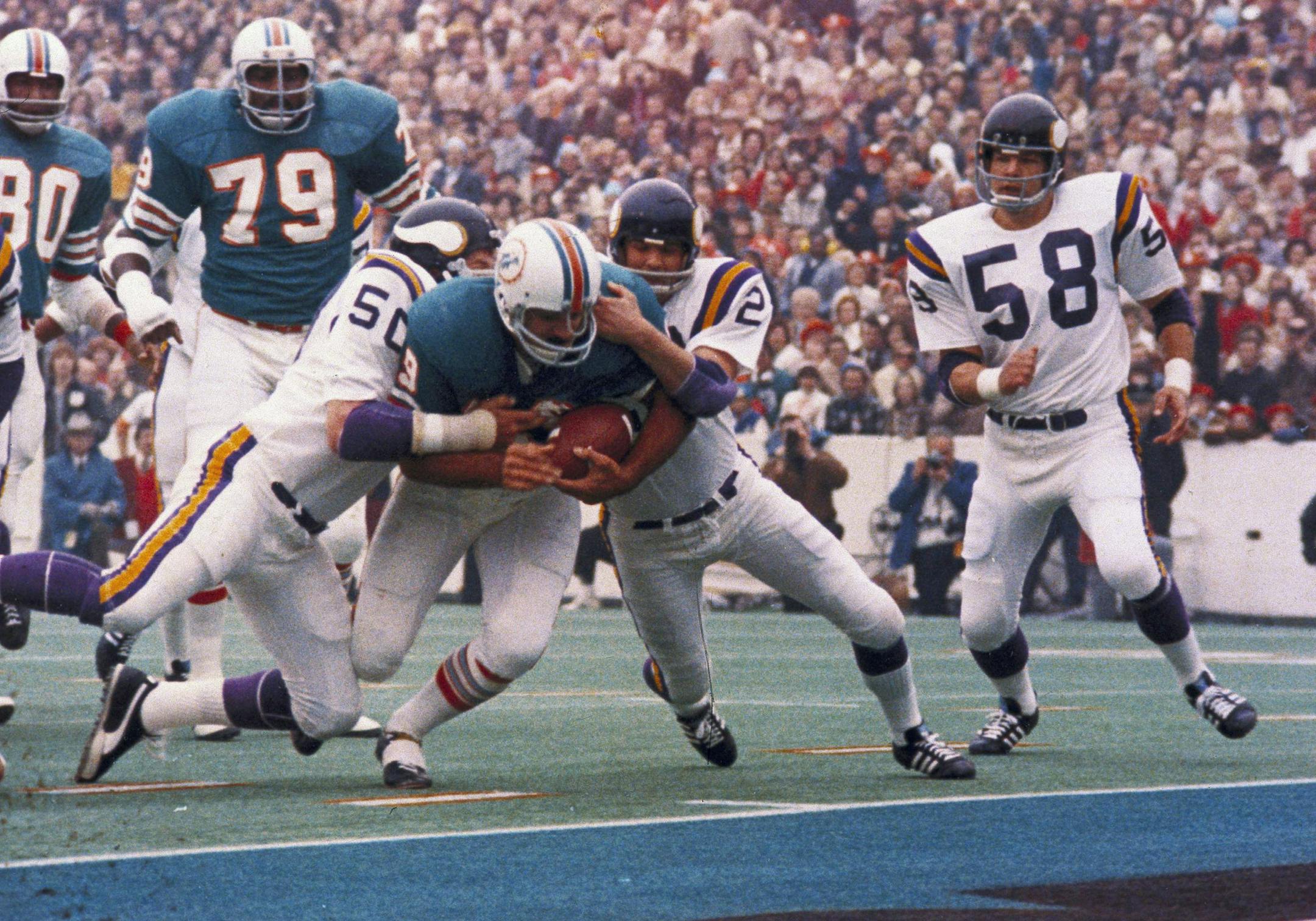 Miami Dolphins Larry Csonka racing through the Minnesota Vikings line. Miami defeated the Vikings 14-7 to win Super Bowl VIII, at the Los Angeles Coliseum, January 14, 1974 (AP Photo) ORG XMIT: APHS83753
