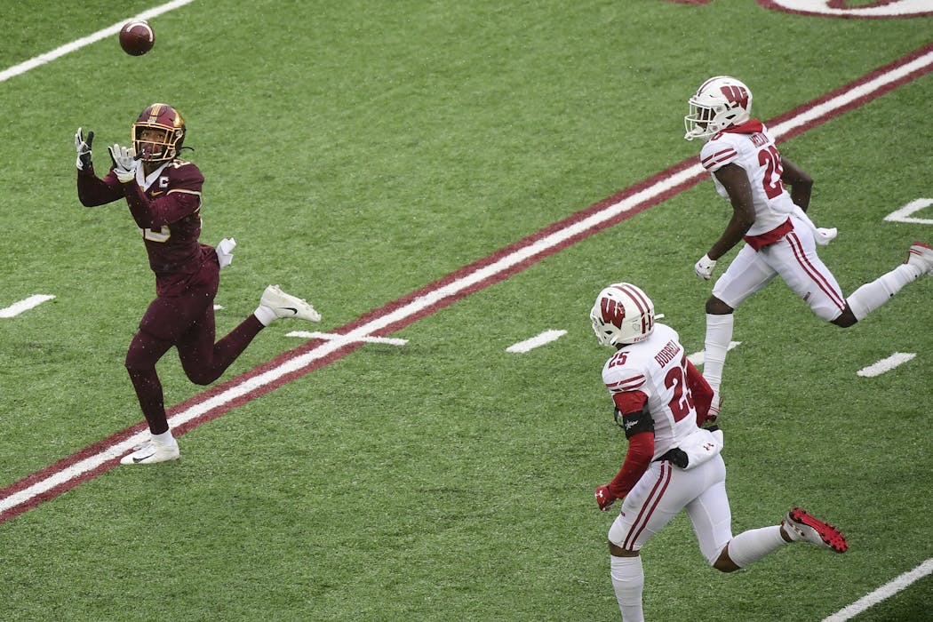 Wide receiver Rashod Bateman (13) scored a touchdown with Wisconsin Badgers safety Eric Burrell (25) and cornerback Semar Melvin (20) in pursuit.