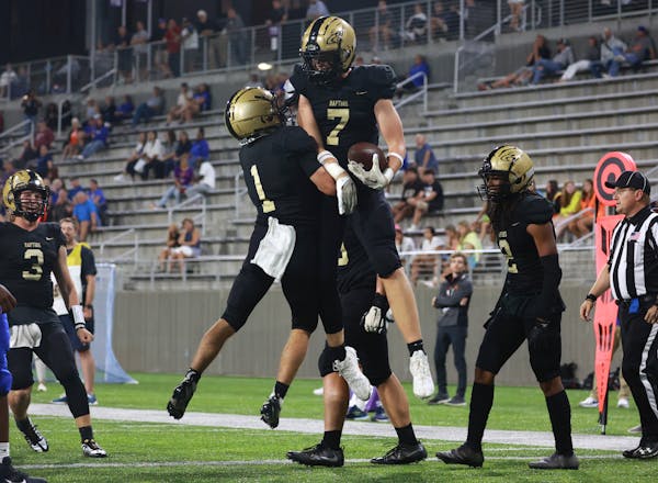 East Ridge players Riley Schwellenbach (1) and Jack Tharaldson (7) celebrate Tharaldson's touchdown reception in the third quarter. Photo by Cheryl A.