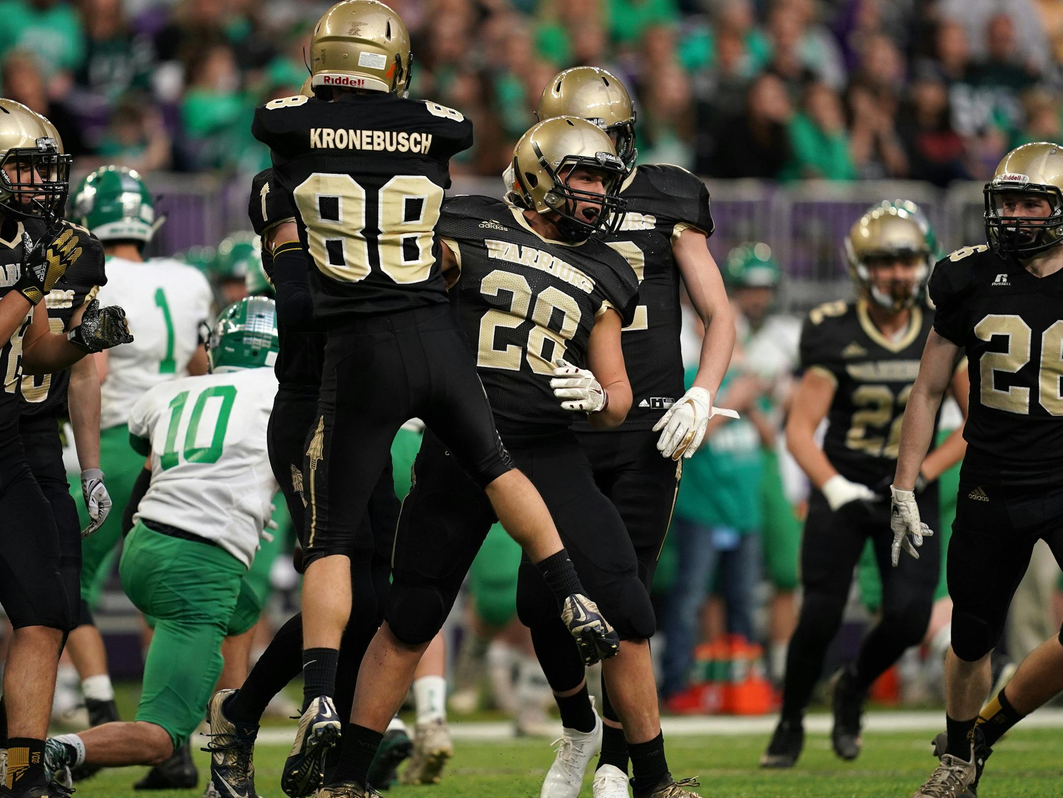 Caledonia fullback Jed Kasten (28) was congratulated by Caledonia wide receiver Cole Kronebush (88) after making a tackle in the first half. ] ANTHONY SOUFFLE ï anthony.souffle@startribune.com Caledonia High School played Paynesville Area High School in a MSHSL Class 2A football semifinal game Thursday, Nov. 15, 2018 at U.S. Bank Stadium in Minneapolis.