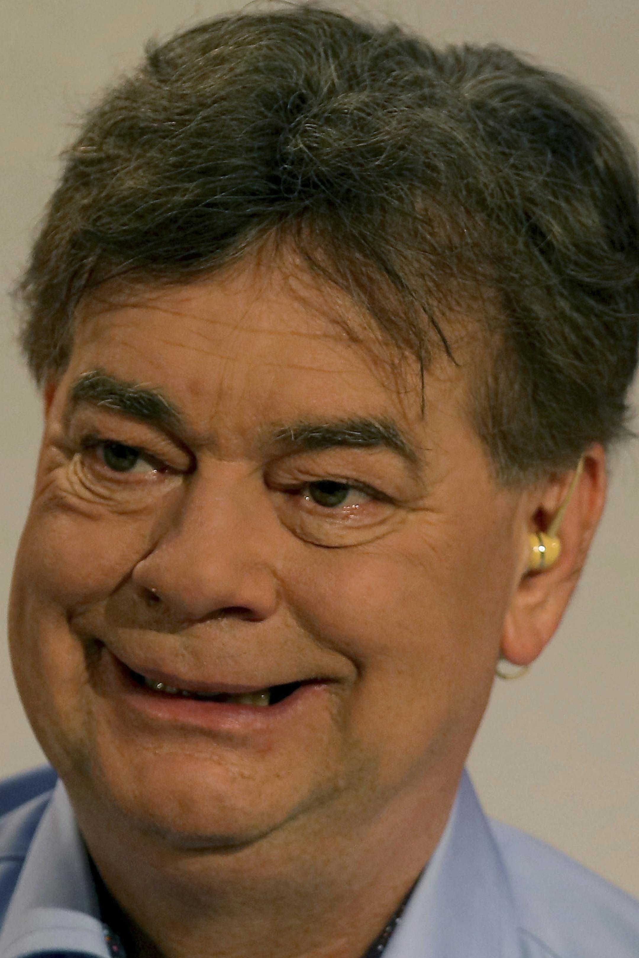 Werner Kogler of the Austrian Greens smiles prior to a TV interview after the closing of the polling stations for the Austrian national elections in Vienna, Austria, Sunday, Sept. 29, 2019. (AP Photo/Ronald Zak)