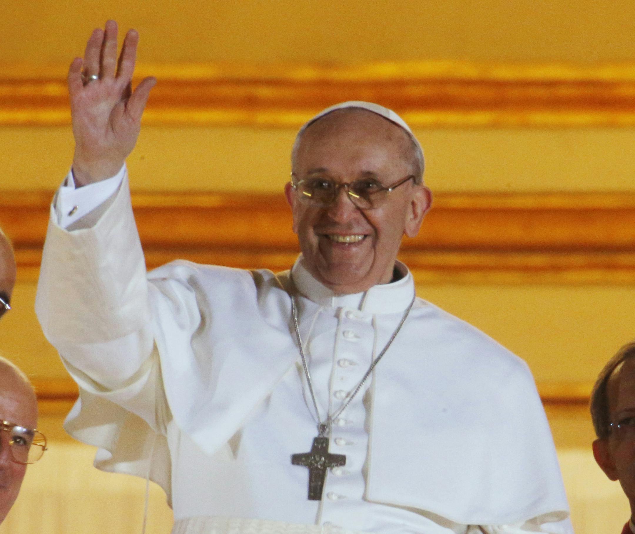 Pope Francis waves to the crowd from the central balcony of St. Peter's Basilica at the Vatican, Wednesday, March 13, 2013. Cardinal Jorge Bergoglio, who chose the name of Francis is the 266th pontiff of the Roman Catholic Church. (AP Photo/Dmitry Lovetsky) ORG XMIT: MIN2013031316262355