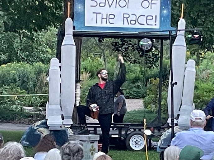 Justin Spenner, center, in Pickup Truck Opera's "Faust" Thursday in Loring Park. Mephistopheles (Justin Anthony Spenner) sings the praises of a versatile but highly toxic substance called "deemonium" in Mixed Precipitation's adaptation of Charles Gounod's opera, "Faust," being presented at parks, gardens and wineries in Minnesota through Sept. 15. (Photo: Scotty Reynolds)