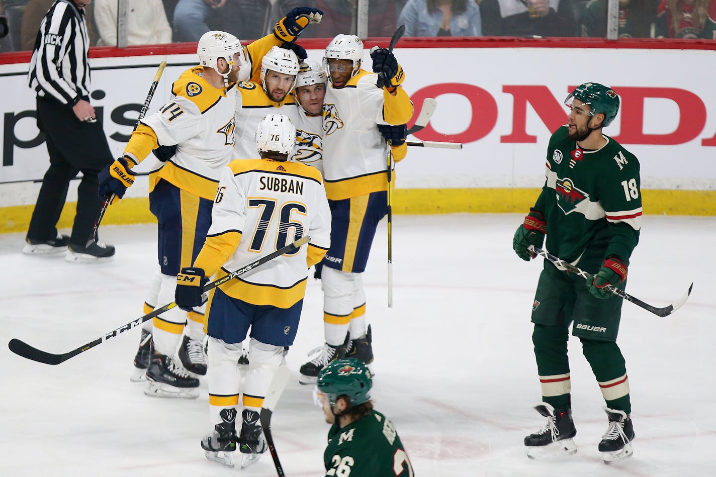 The Predators' Mattias Ekholm (4) Nick Bonino (13), Rocco Grimaldi (23) and Wayne Simmonds (17) celebrated after Bonino scored a first-period goal against the Wild on Sunday.