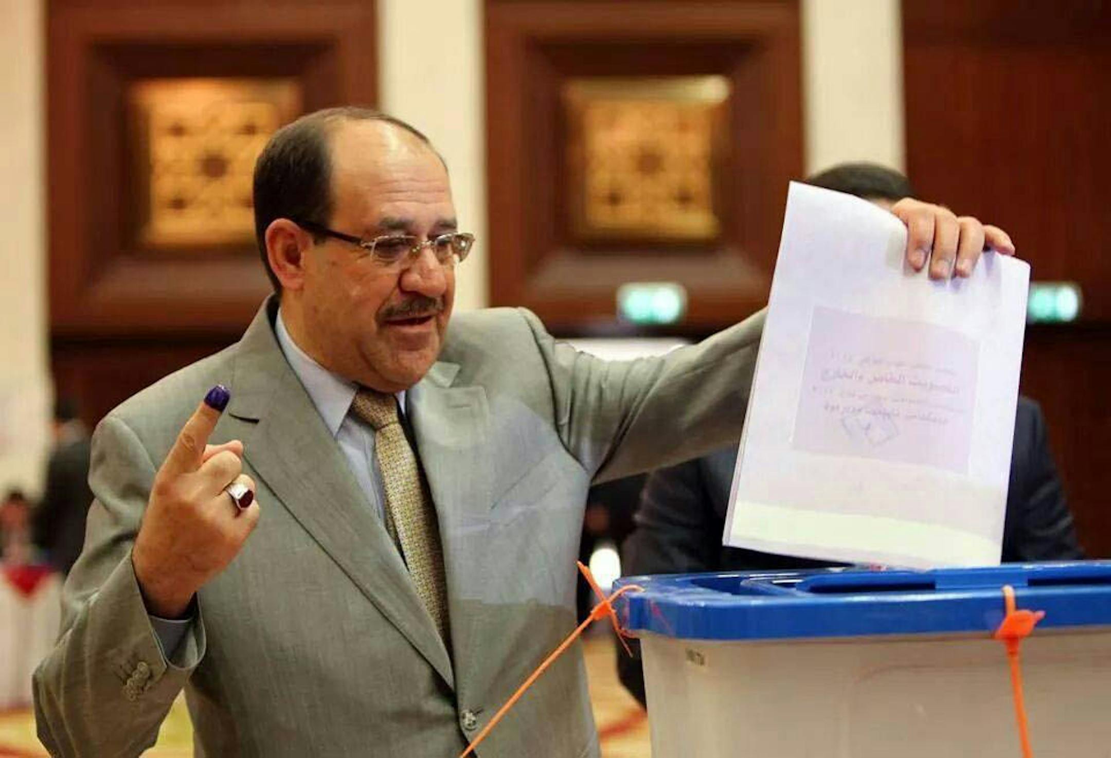 Iraqi Prime Minister Nouri al-Maliki prepares to casts his vote at a polling station in the heavily fortified Green Zone in Baghdad, Iraq, Wednesday, April 30, 2014. Iraqis braved the threat of bombs and other violence to vote Wednesday in parliamentary elections amid a massive security operation as the country slides deeper into sectarian strife. (AP Photo) ORG XMIT: MIN2014050817240962