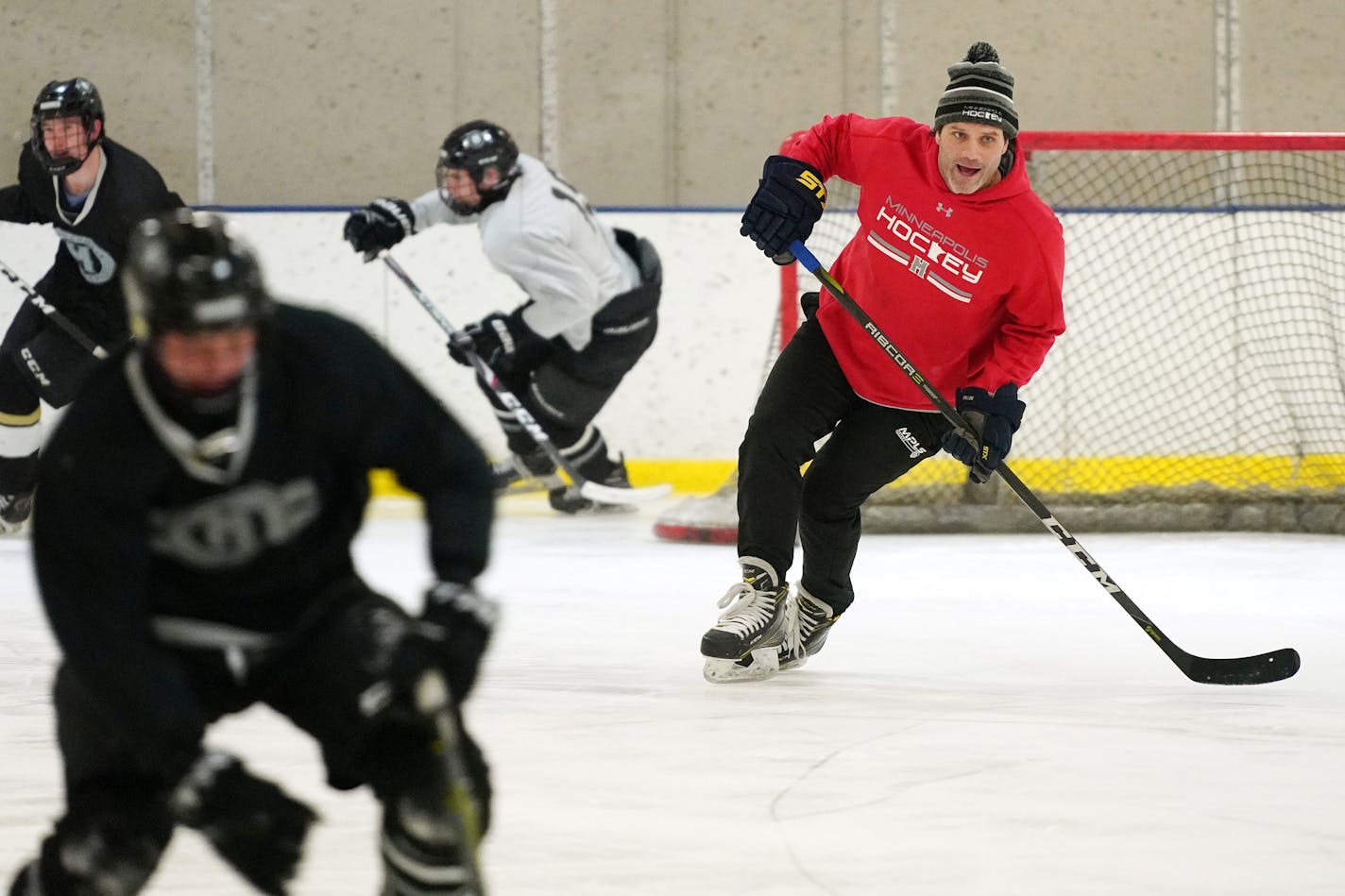 Minneapolis hockey coach Joe Dziedzic skated with his players during practice last week at the Northeast Ice Arena in Minneapolis.