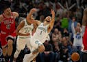 Wolves forward Kyle Anderson (1) was fouled by Bulls center Nikola Vucevic (9) in the fourth quarter Sunday night at Target Center.