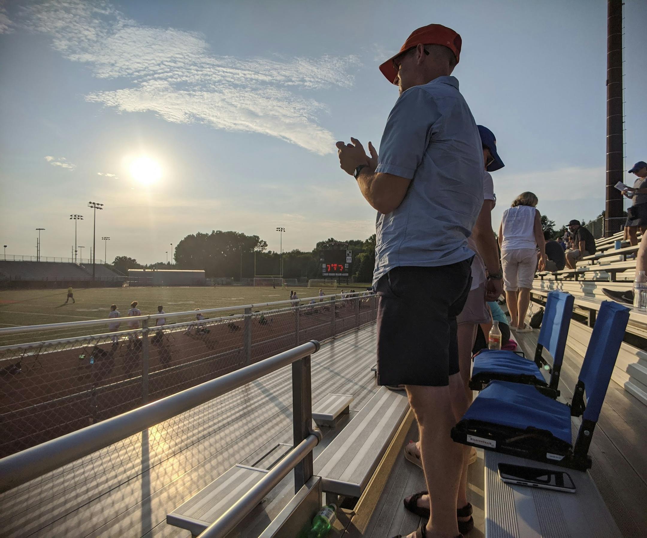 Darren Selberg stood and applauded after the Minneapolis Washburn girls' soccer team finished its game Thursday at Eden Prairie. His daughter, Lillian, plays for the Millers, who lost 2-0 in their season opener. Photo by Paul Klauda