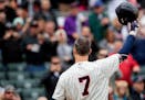 Minnesota Twins first baseman Joe Mauer tipped his hat to the cheering crowd before his first at bat on the final game of the season. ] CARLOS GONZALE