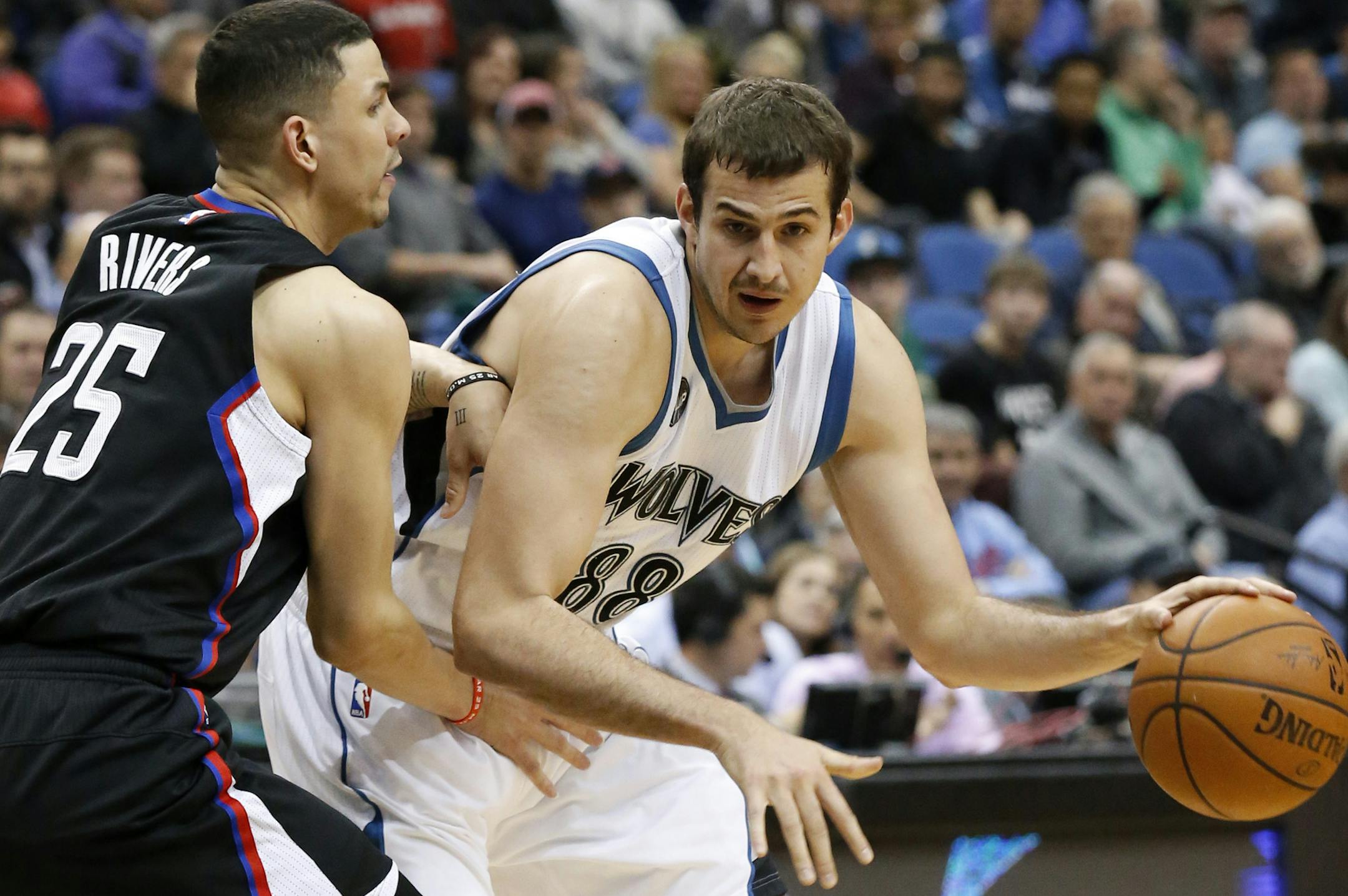 Minnesota Timberwolves forward Nemanja Bjelica (88) drives against Los Angeles Clippers guard Austin Rivers (25) during the first half of an NBA basketball game in Minneapolis, Wednesday, March 30, 2016. (AP Photo/Ann Heisenfelt)
