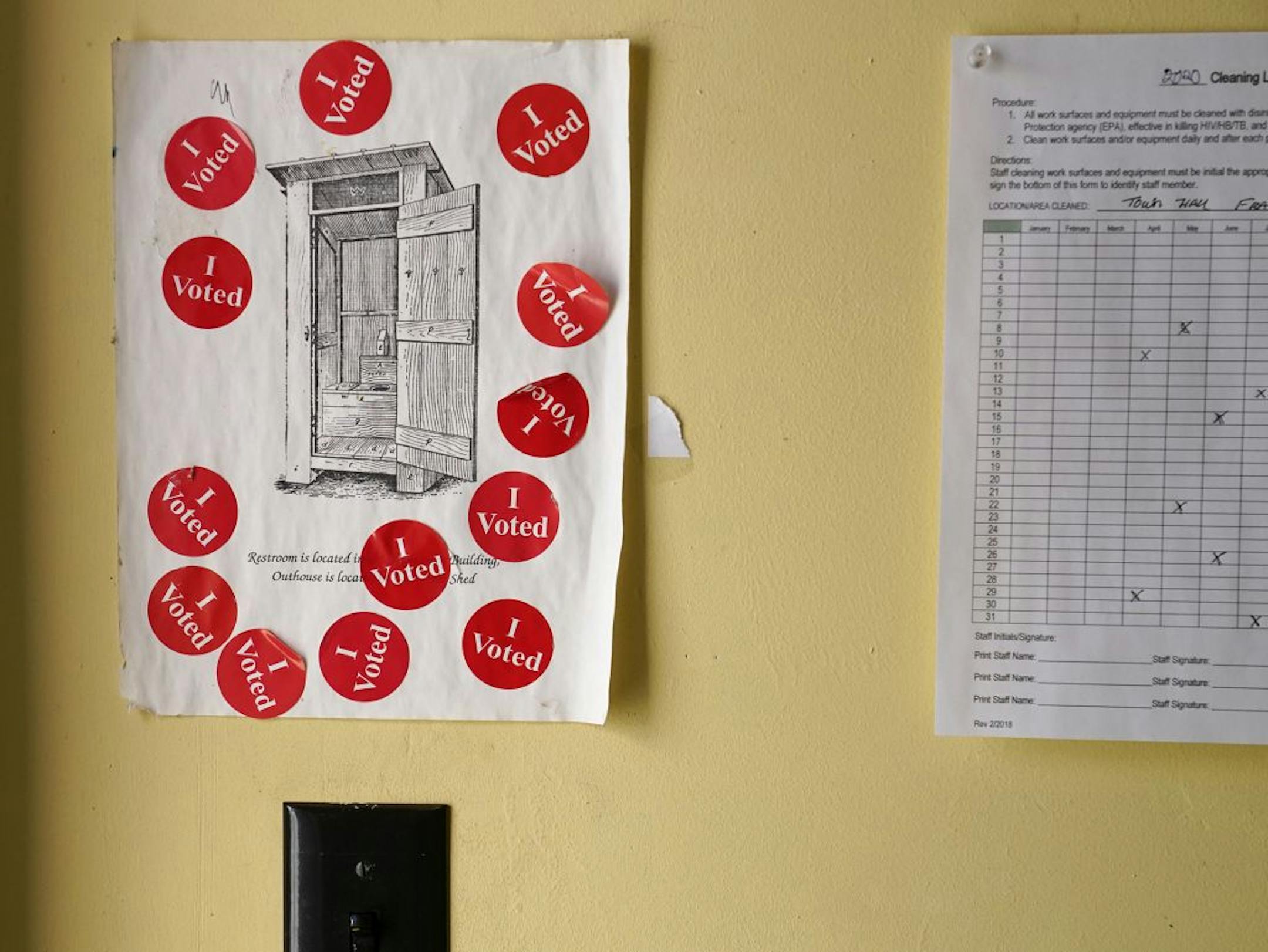 Several voters left their stickers on a sign for an outhouse Tuesday at Franconia Township Town Hall in Shafer.