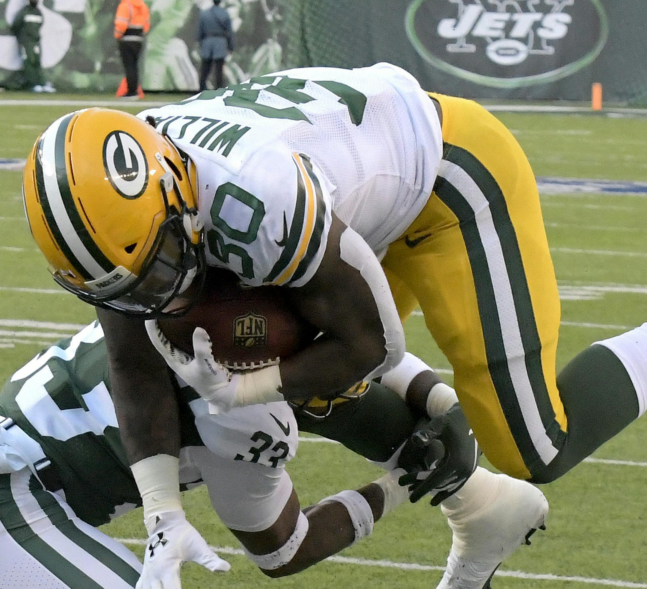 Green Bay Packers running back Jamaal Williams (30) leaps toward the end zone as New York Jets strong safety Jamal Adams tries to stop him during the first half of an NFL football game, Sunday, Dec. 23, 2018, in East Rutherford, N.J. Williams scored on the play. (AP Photo/Bill Kostroun)
