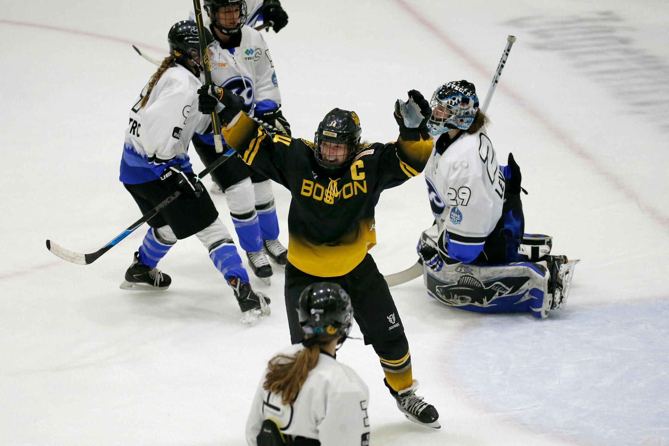 Boston Pride forward Jillian Dempsey (14) celebrates after scoring a goal against Minnesota Whitecaps goalie Amanda Leveille (29) during the second period of the NWHL Isobel Cup championship hockey game Saturday, March 27, 2021, in Boston. (AP Photo/Mary Schwalm)