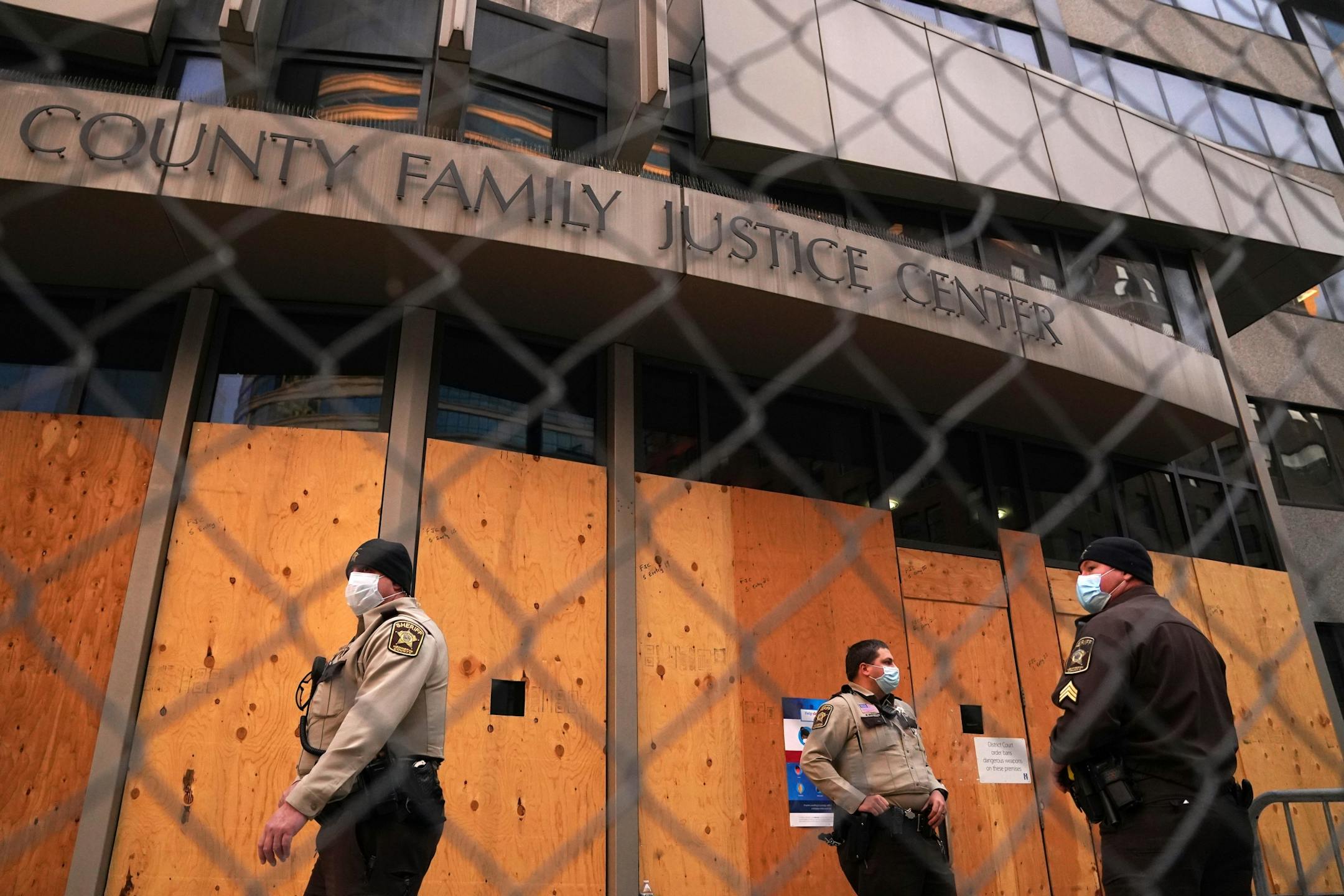 Sheriff's deputies stood guard outside the boarded-up Hennepin County Family Justice Center ahead of Friday's hearing in downtown Minneapolis.
