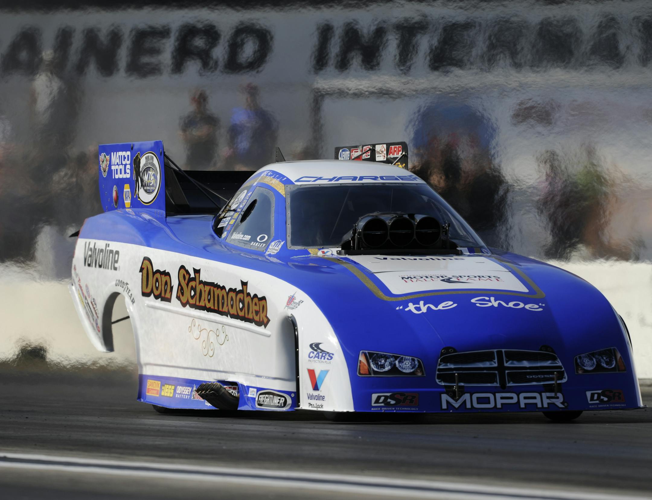 In this photo provided by NHRA, Funny Car driver Jack Beckman goes down the track during qualifying on Saturday, Aug. 17, 2013, in his new Don Schumacher Hall of Fame Tribute Dodge Charger at the Lucas Oil NHRA Nationals drag races at Brainerd International Raceway in Brainerd, Minn. Beckman qualified No. 1 after going 4.038 seconds at 313.37 mph. (AP Photo/NHRA, Marc Gewertz)
