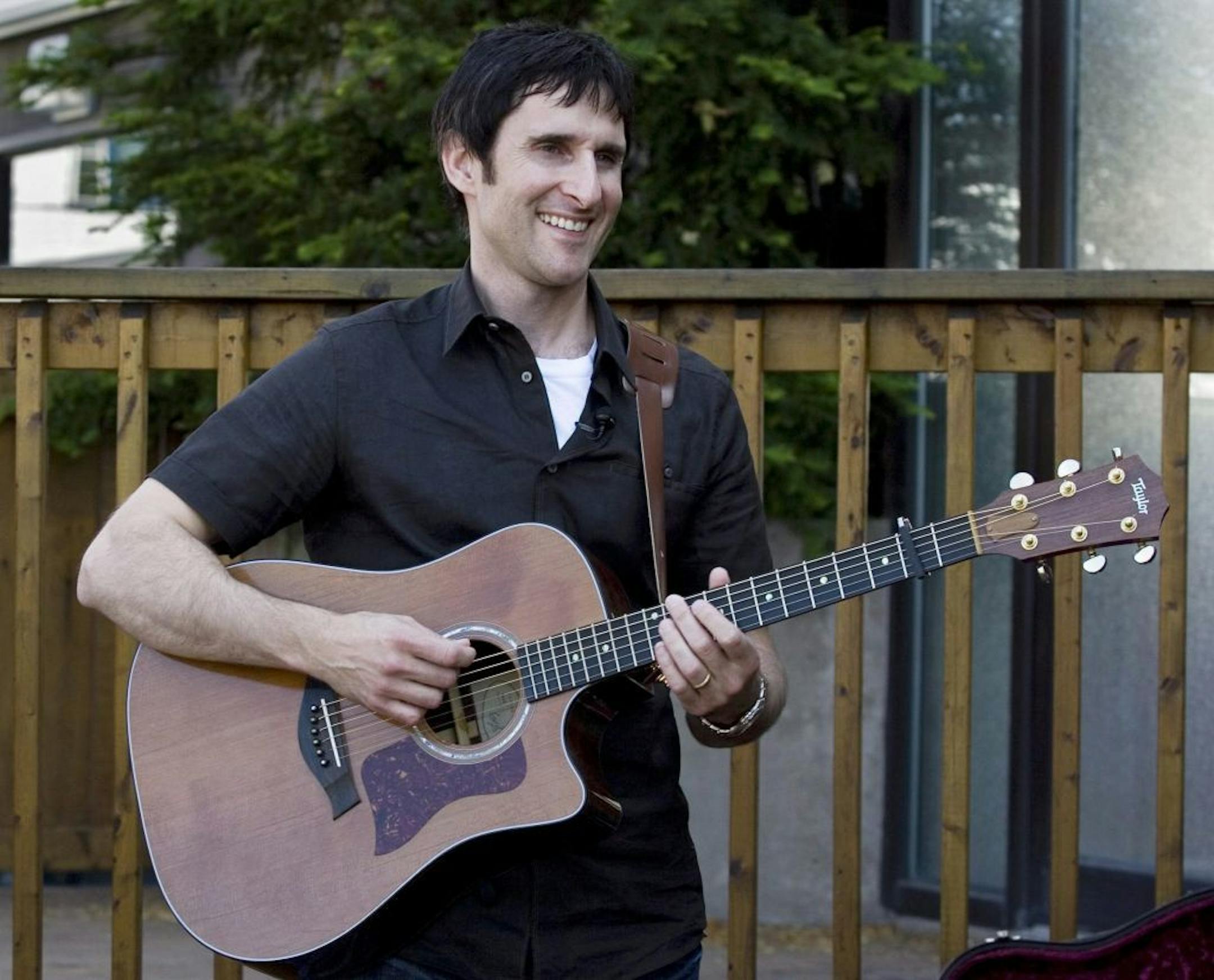 FILE - In this July 9, 2009 file photo, Musician Dave Carroll, of the pop-folk band Sons Of Maxwell, holds his repaired Taylor guitar in Halifax, Nova Scotia. Carroll became an Internet sensation after posting a revenge song about airline customer service on YouTube with his song "United Breaks Guitars."