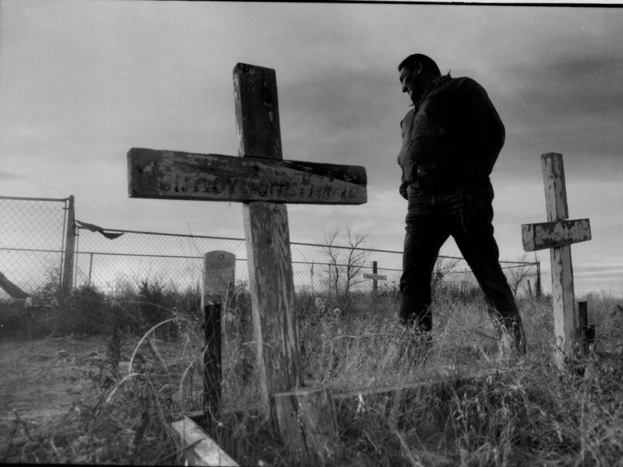 December 9, 1990 Cornelius Kills Small, whose grandfather was injured in the battle at Wounded Knee,walked among the gravesite markers at the Wounded Knee Mass grave Cemetery. December 6, 1990