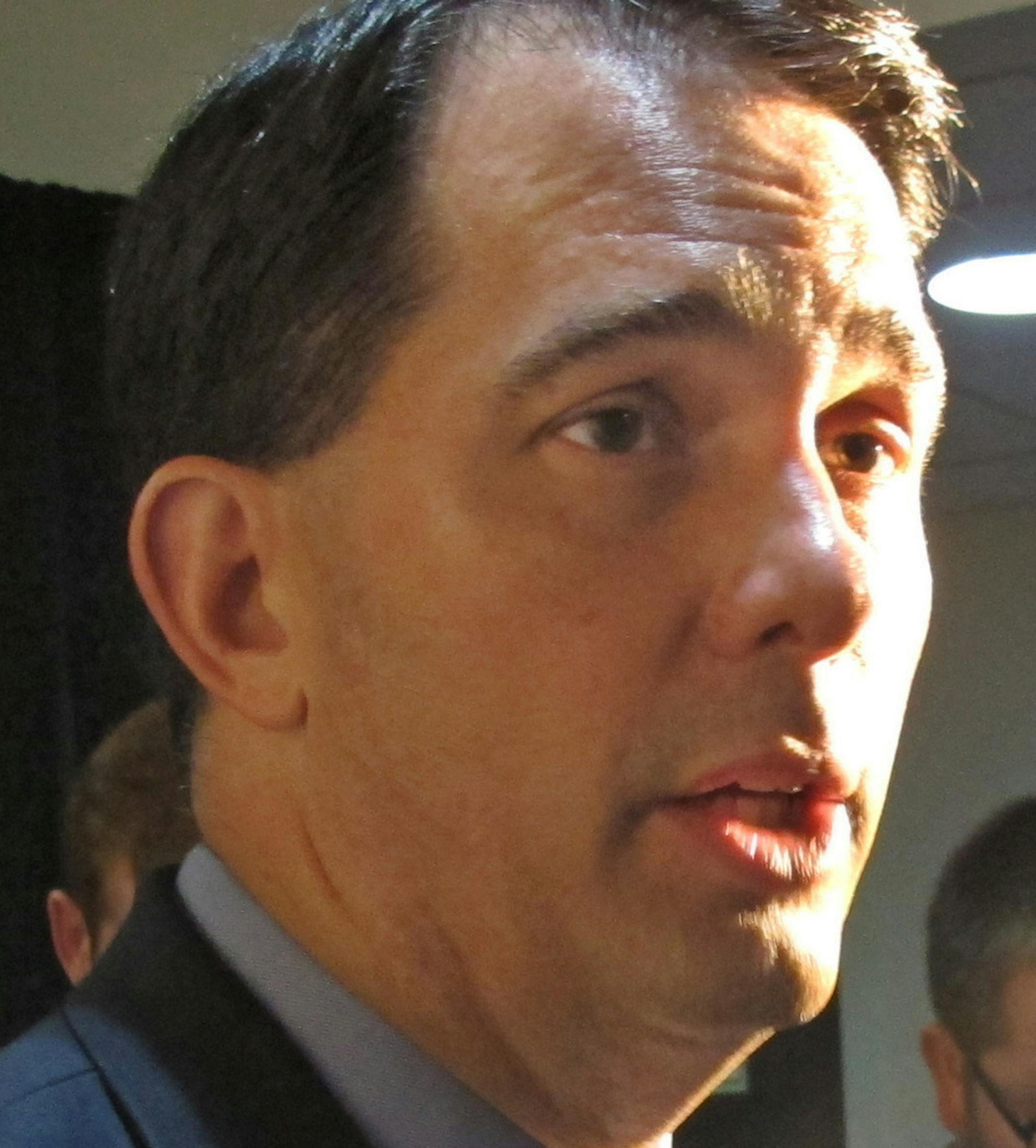 Gov. Scott Walker speaks to the media Wednesday, June 8, 2016, in Madison, Wis. Walker said he wants presumptive Republican presidential nominee Donald Trump to renounce comments he made about a federal judge's Mexican heritage.(AP Photo/Scott Bauer)