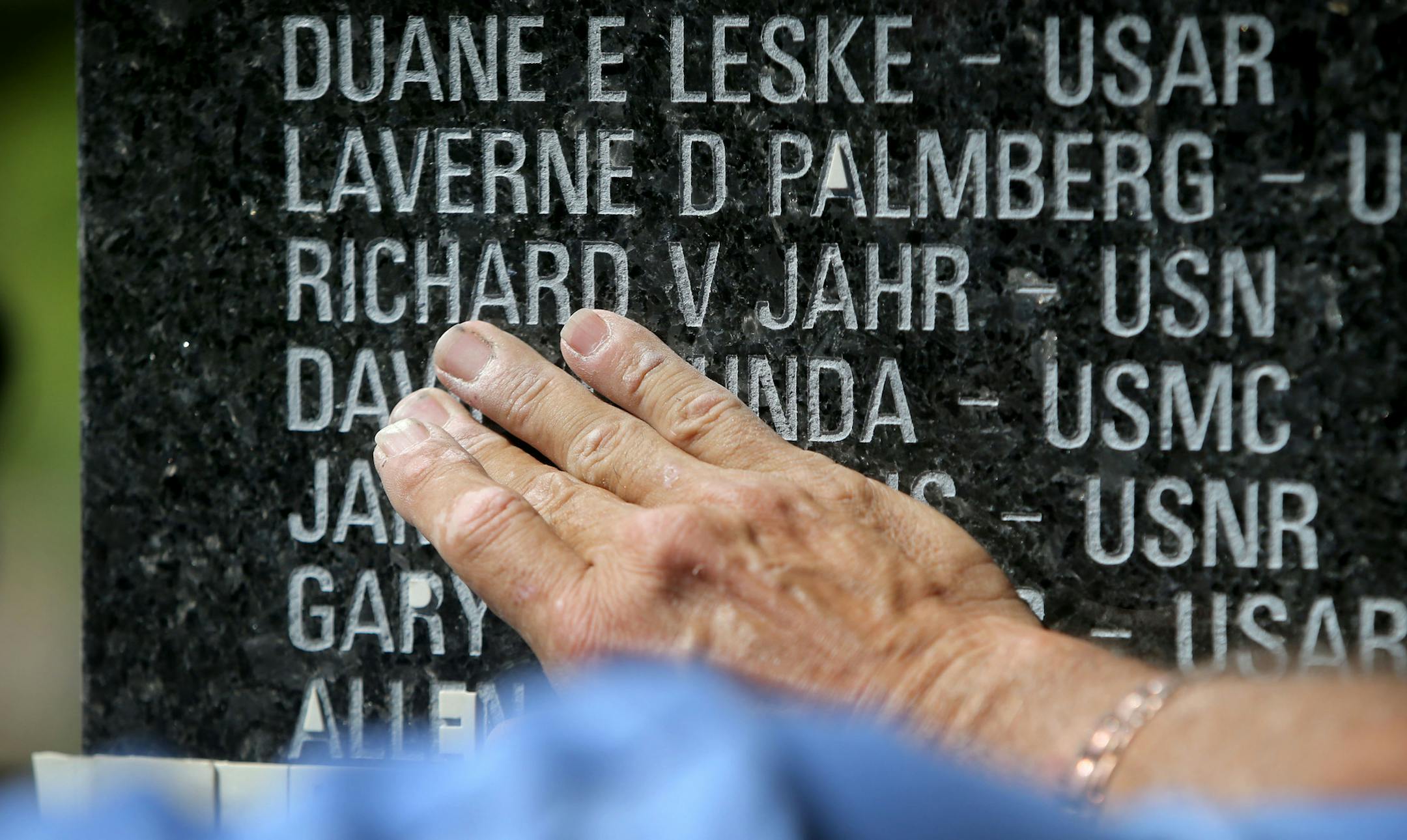 Engraver Wayne Winkelman, who owns and operates Winkelman Cemetery Lettering in St. Cloud, wipes away rubber residue from a teamplate after he sand blasted the names of the first to go onto the Minnesota black granite Memorial Tuesday, June 16, 2015, near the southwest corner of the Hilde Performance Center at 3500 Plymouth Blvd. in Plymouth, MN. ](DAVID JOLES/STARTRIBUNE)djoles@startribune.com Plymouth is honoring area veterans with a new memorial that will be unveiled this month. Crews started