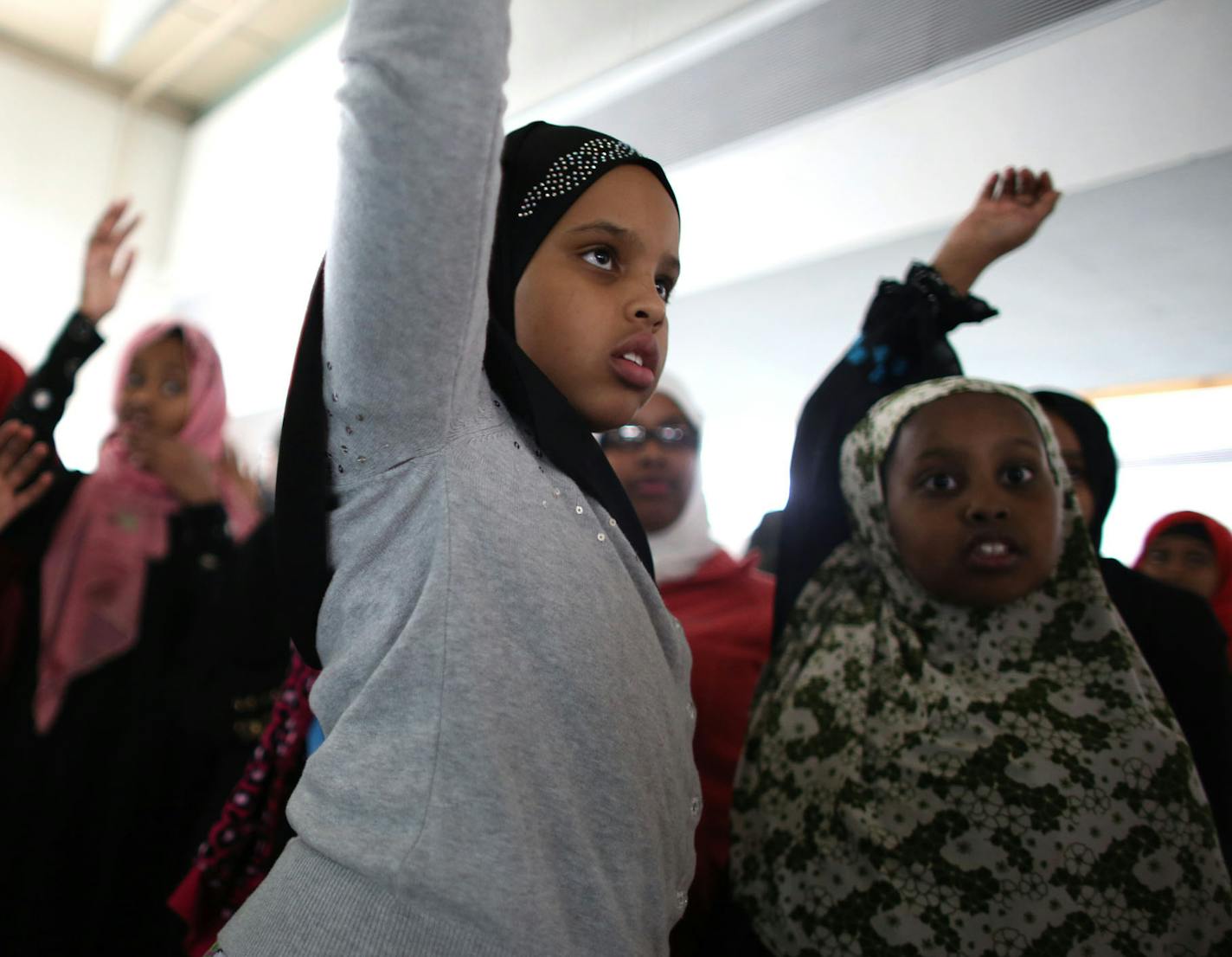 Shekri Jama, 9. raised her hand along with some other students before a girl's only water safety class at theYMCA in downtown St. Paul, Min., Tuesday, November 9, 2013. ] (KYNDELL HARKNESS/STAR TRIBUNE) kyndell.harkness@startribune.com