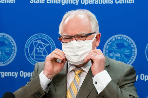 Minnesota Gov. Tim Walz put his mask back on at the conclusion of a news conference Tuesday.