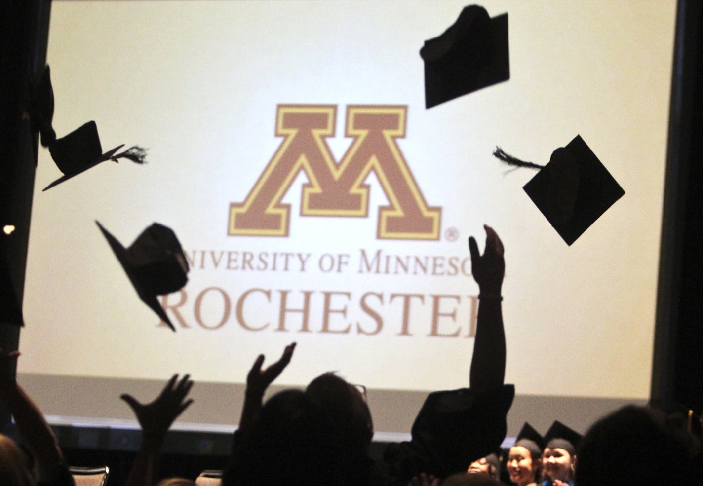 Following the graduation ceremony, the first-ever class of graduates at the University of Minnesota, Rochester toss their mortar boards into the air at the Mayo Civic Center Saturday, May 18, 2013 in Rochester, MN.] JOLES/STARTRIBUNE) djoles@startribune The first-ever class of undergrads at the University of Minnesota, Rochester graduate this weekend. When they began as freshmen, there were no dorms, no upperclassmen, no mascot.