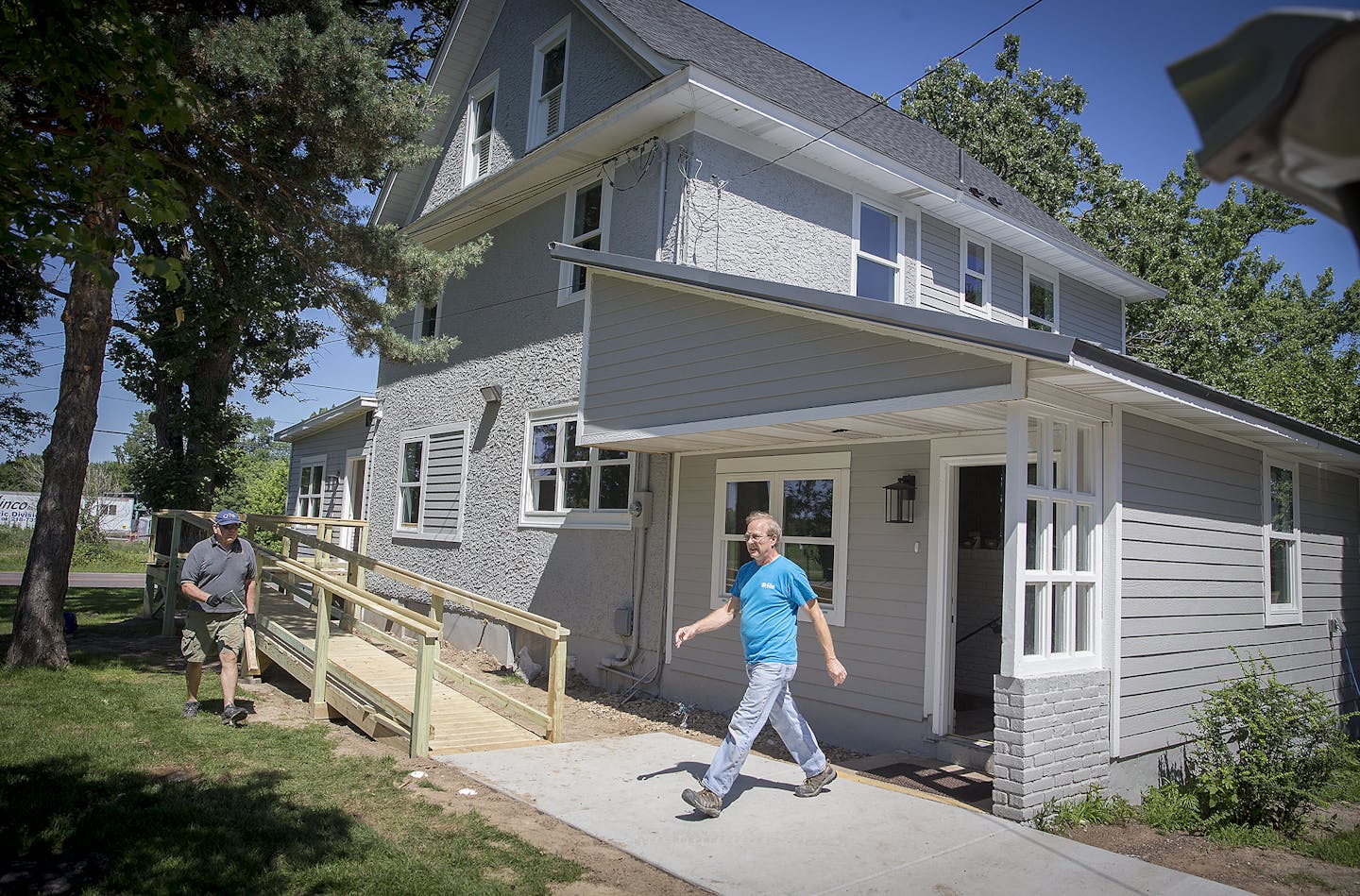 Volunteers Harvey Taipale, left, and Bob Bailey worked last week to finish a shelter for homeless families in Hugo that should open this month.