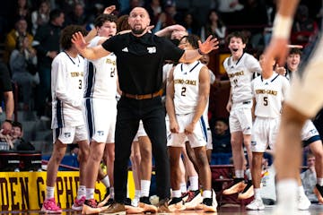 Totino-Grace coach Nick Carroll sends a message to his team Saturday during the Class 3A championship game.