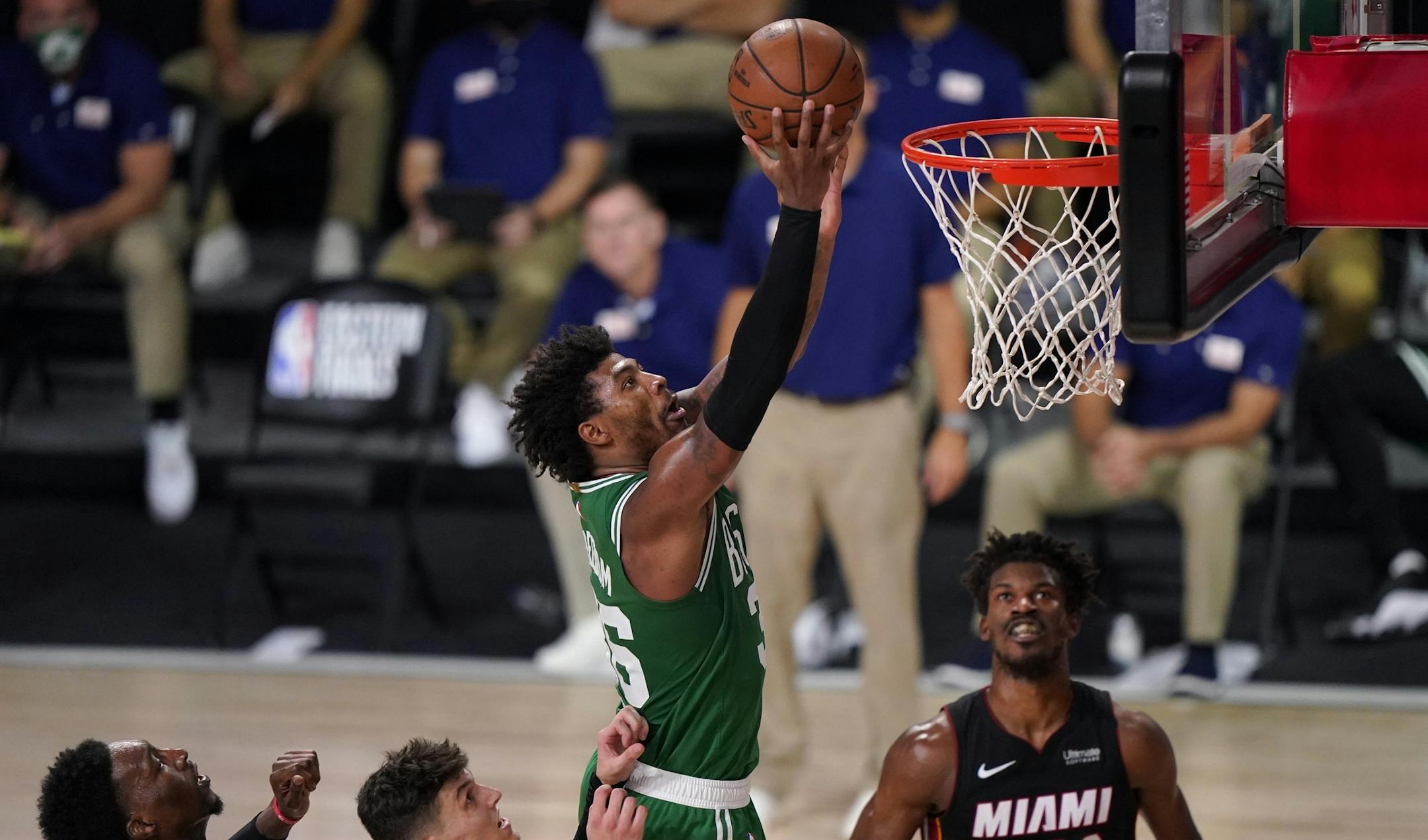 Boston Celtics guard Marcus Smart (36) takes a shot over Miami Heat's Bam Adebayo, from bottom left, Tyler Herro and Jimmy Butler (22) during the second half of Game 4 of an NBA basketball Eastern Conference final, Wednesday, Sept. 23, 2020, in Lake Buena Vista, Fla. (AP Photo/Mark J. Terrill)