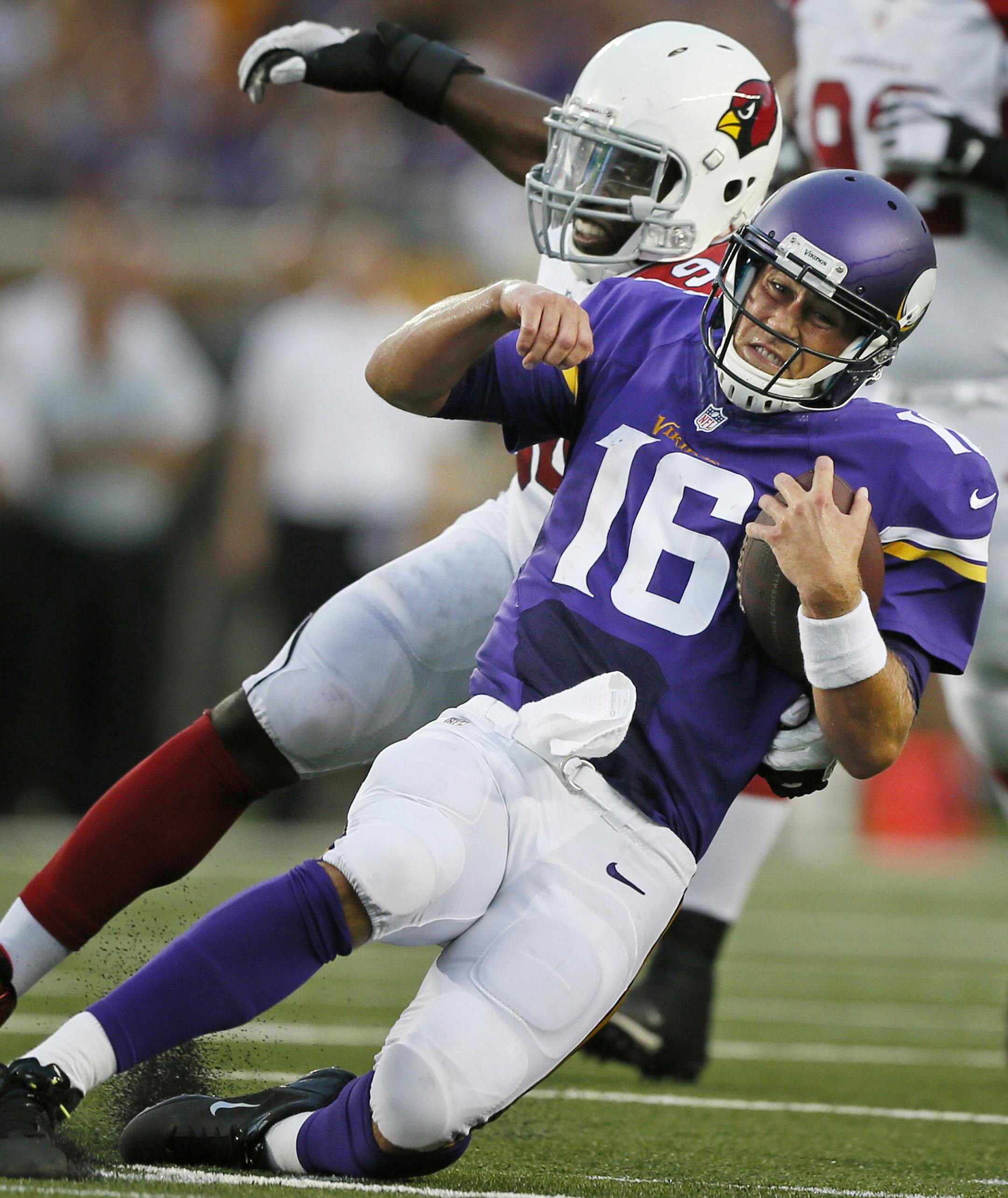 Minnesota Vikings quarterback Matt Cassel (16) slides in for a first down over Arizona Cardinals outside linebacker Sam Acho (94) during NFL pre-season action between the Minnesota Vikings and the Arizona Cardinals at TCF Bank Stadium Saturday August 16 , 2014 in Minneapolis MN . ] Jerry Holt Jerry.holt@startribune.com