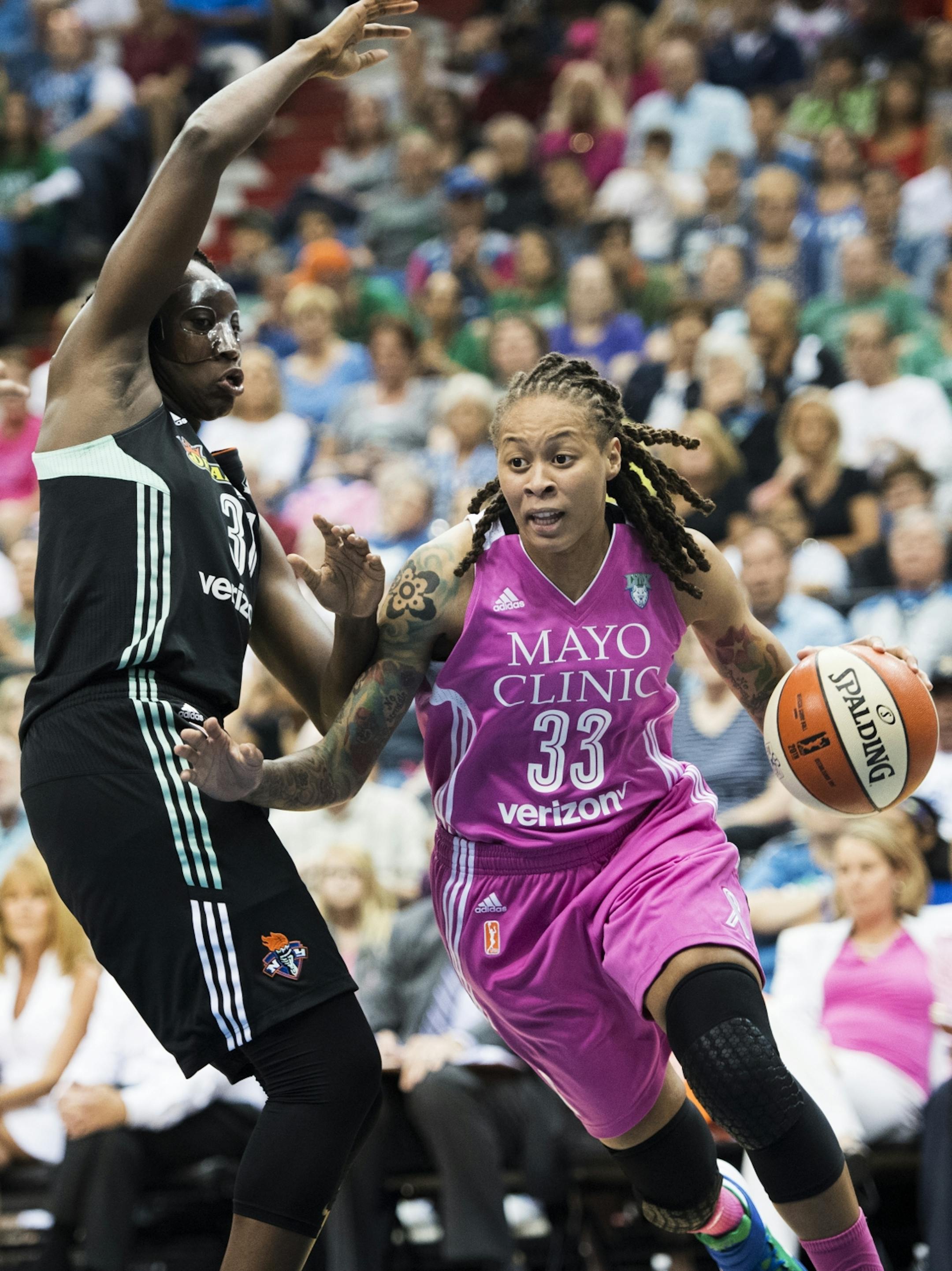 Minnesota Lynx guard Seimone Augustus (33) drove towards the hoop past New York Liberty guard Tanisha Wright (30).