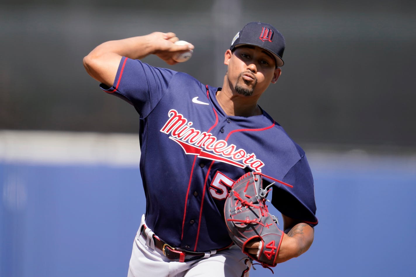 Minnesota Twins pitcher Jhoan Duran (59) delivers a pitch in the eighth inning during a spring training baseball game against the Tampa Bay Rays at the Charlotte Sports Park Tuesday March 29, 2022, in Port Charlotte, Fla. The Rays won the game 4-2. (AP Photo/Steve Helber)