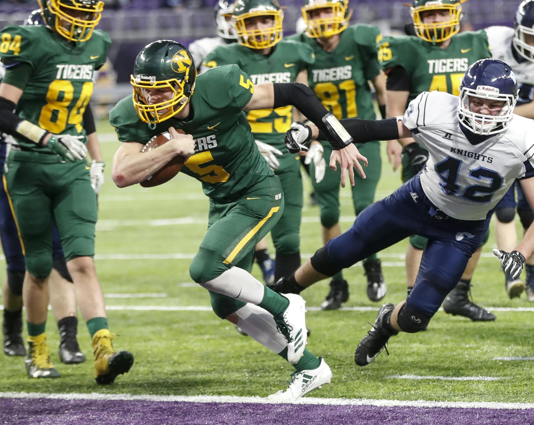 Nevis High School quarterback Jack DeWulf (5) rushed for a touchdown during the first half.] RENEE JONES SCHNEIDER • renee.jones@startribune.com During the Nine-Man football state semifinals between Nevis and Russell-Tyler-Ruthton at U.S. Bank Stadium in Minneapolis, Minn., on Friday, November 17, 2017.