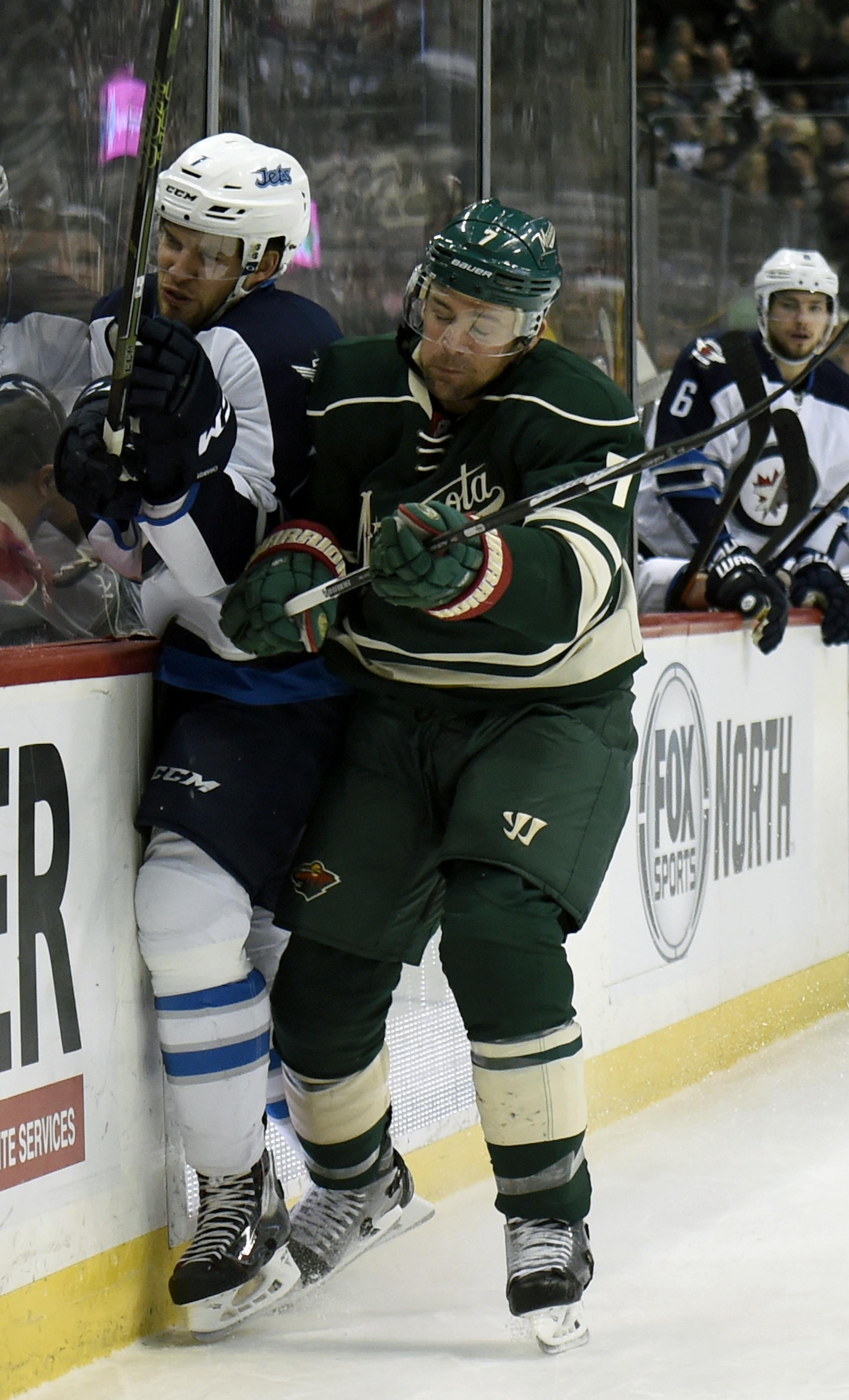 Minnesota Wild left wing Chris Porter, right, checks Winnipeg Jets defenseman Ben Chiarot during the second period of an NHL hockey game Friday, Jan. 15, 2016, in St. Paul, Minn. (AP Photo/Hannah Foslien)