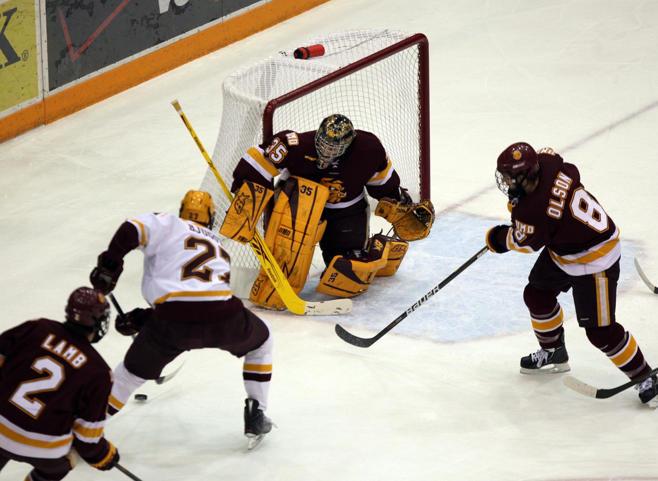 The Gophers' Max Gardiner (22) skated in on Minnesota Duluth goalie Kenny Reiter.