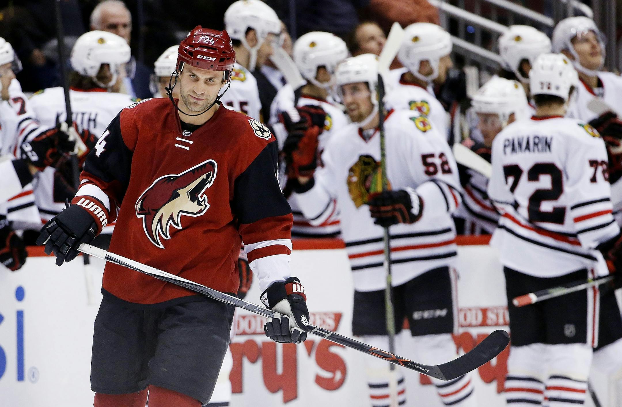 Arizona Coyotes' Kyle Chipchura, left, skates away as Chicago Blackhawks' Erik Gustafsson (52), of Sweden, and Artemi Panarin (72), of Russia, celebrate a goal by Jonathan Toews during the second period of an NHL hockey game Thursday, Feb. 4, 2016, in Glendale, Ariz. (AP Photo/Ross D. Franklin)