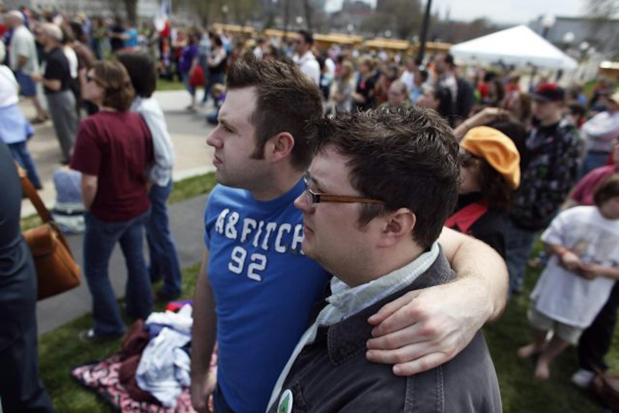 Anthony Nemcek, left, and his partner Andrew Zahorsky will travel to Iowa next week for a legal same-sex wedding, on Thursday the couple attend a GBLT rally at the capitol.