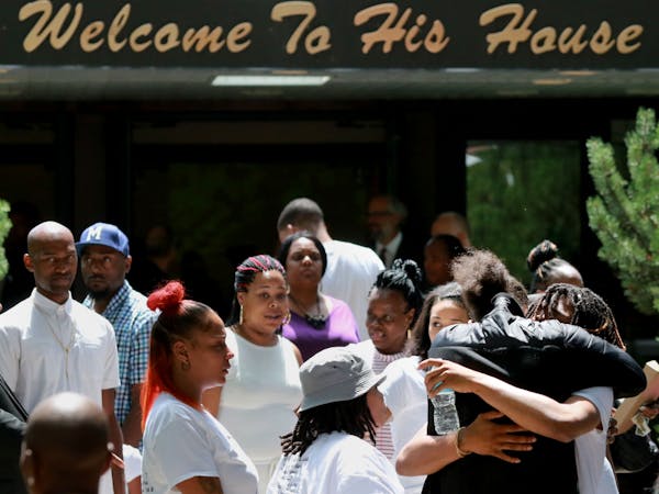Pastor Danny Givens, front right, shakes Mourners leave the church following a celebration of life service for Le'Vonte King Jason Jones, 2, shot and 