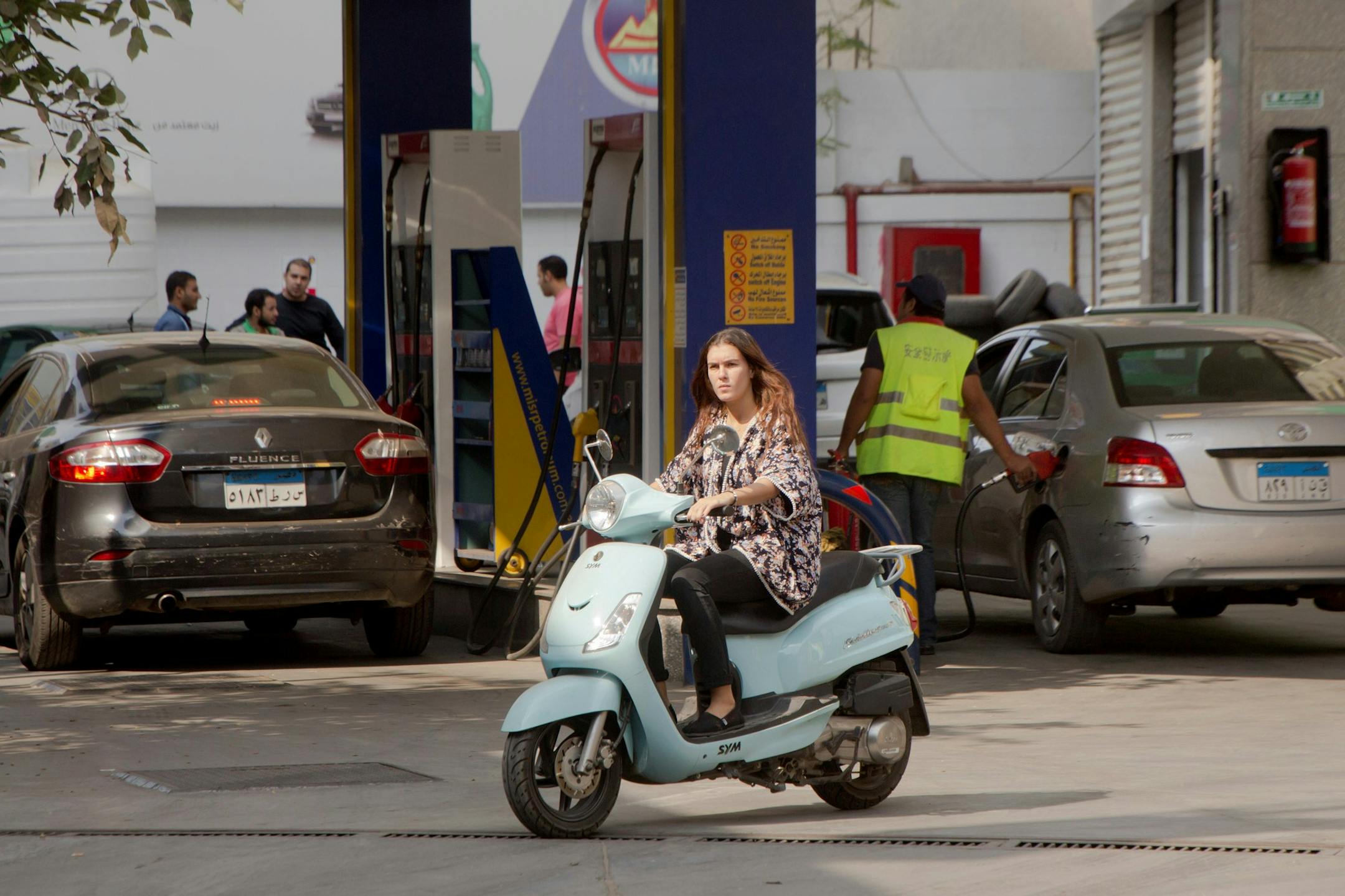 FILE - In this Nov. 4, 2016 file photo, a woman rides her motorbike as she leaves a gasoline station in Cairo, Egypt. Egypt raised the prices of fuel by up to 55 percent, the second such increase since the local currency was floated seven months ago. The move, announced Thursday, June 29, 2017, on the official news agency MENA, comes as part of broader economic reforms taken to meet demands by the International Monetary Fund for a $12 billion bailout loan. (AP Photo/Amr Nabil, File) ORG XMIT: CA