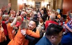 Gun safety advocates from Protect Minnesota and Moms Demand Action chanted and cheered on DFL legislators who plan to vote for bills today that would 
