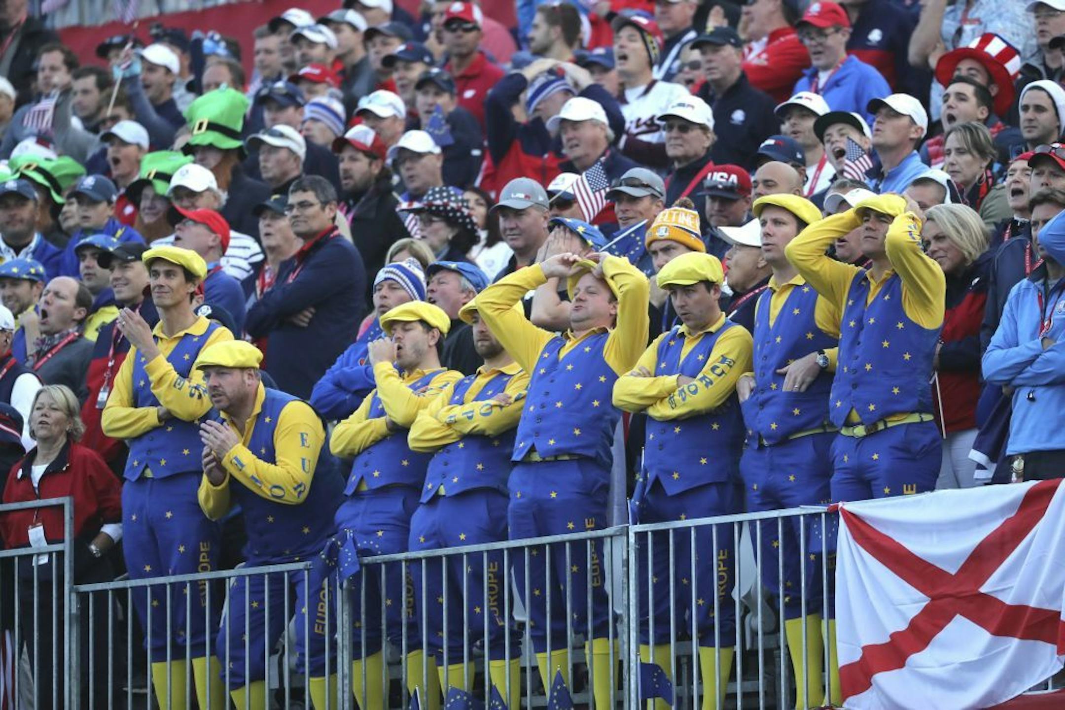 European fans react as players tee-off on the first hole during the foresomes matches at the Ryder Cup golf tournament Friday, Sept. 30, 2016, at Hazeltine National Golf Club in Chaska, Minn.