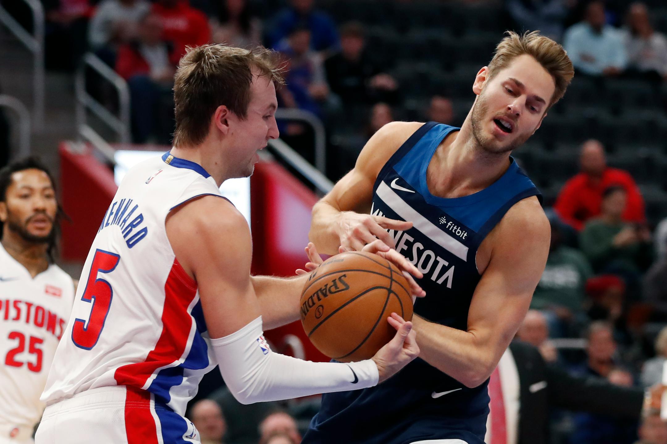 Detroit Pistons guard Luke Kennard (5) takes the ball away from Minnesota Timberwolves forward Jake Layman during the second half