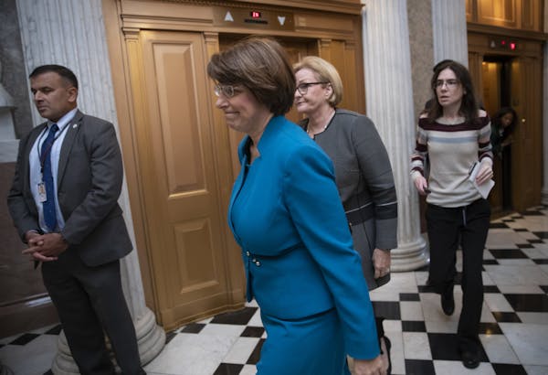 Sen. Amy Klobuchar, D-Minn., a member of the Senate Judiciary Committee, followed by Sen. Claire McCaskill, D-Mo., arrives at the chamber for a proced