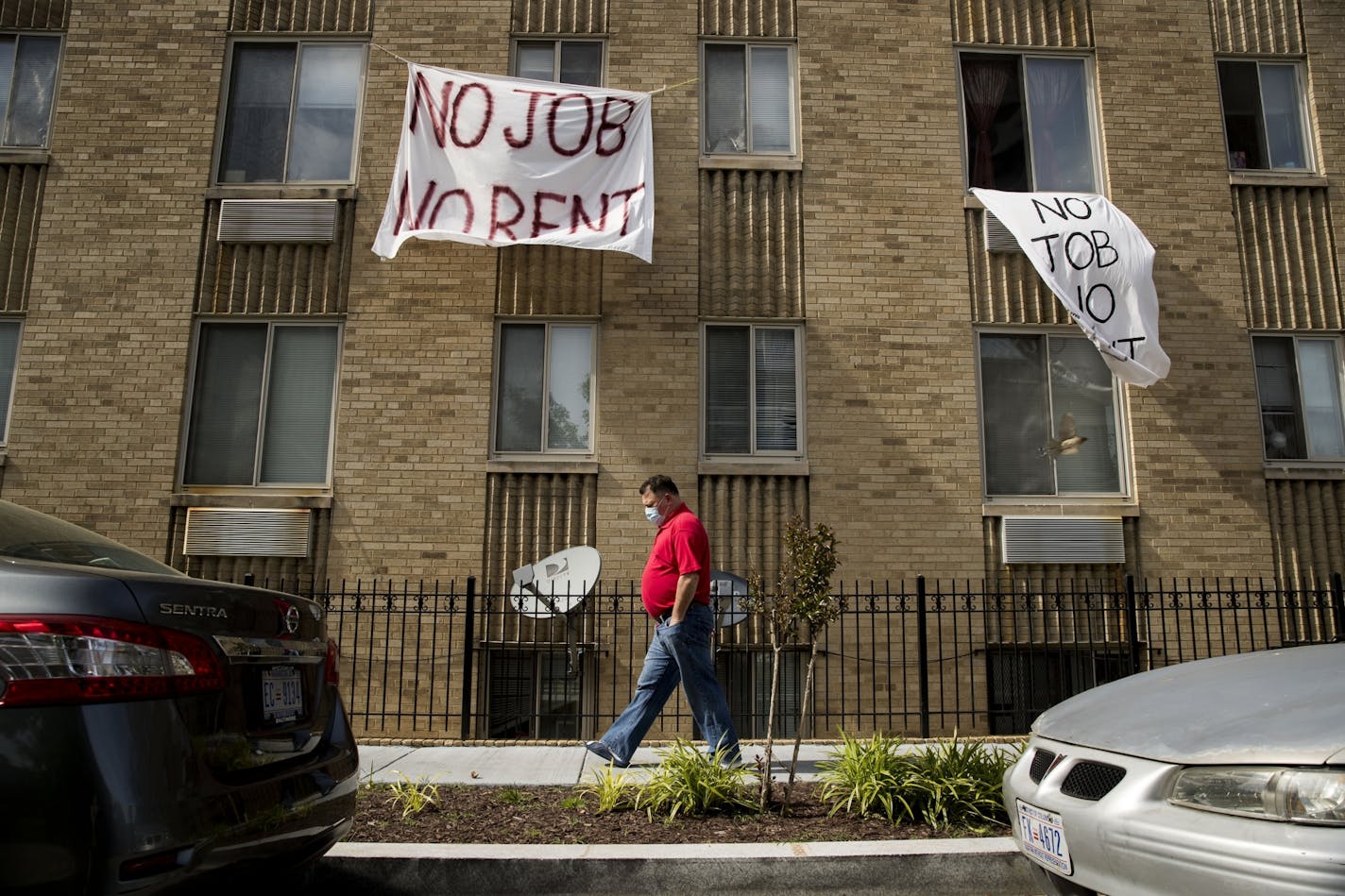 Signs that read "No Job No Rent" hang from the windows of an apartment building during the coronavirus pandemic in Washington, D.C. Landlords across Minnesota bracing for another month with potentially no rent payments after Gov. Tim Walz extended an order preventing evictions through July 13.