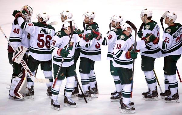 A happy bunch of Wild players celebrated after defeating the Canucks 4-2 in Vancouver on Sunday and completing a 3-0 road trip through western Canada.