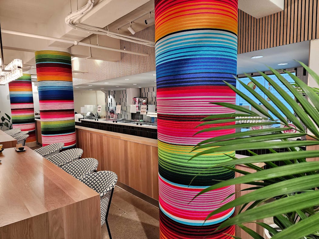 Artist HOTTEA wrapped yarn around historic columns in the new Puralima Cantina in Minneapolis.