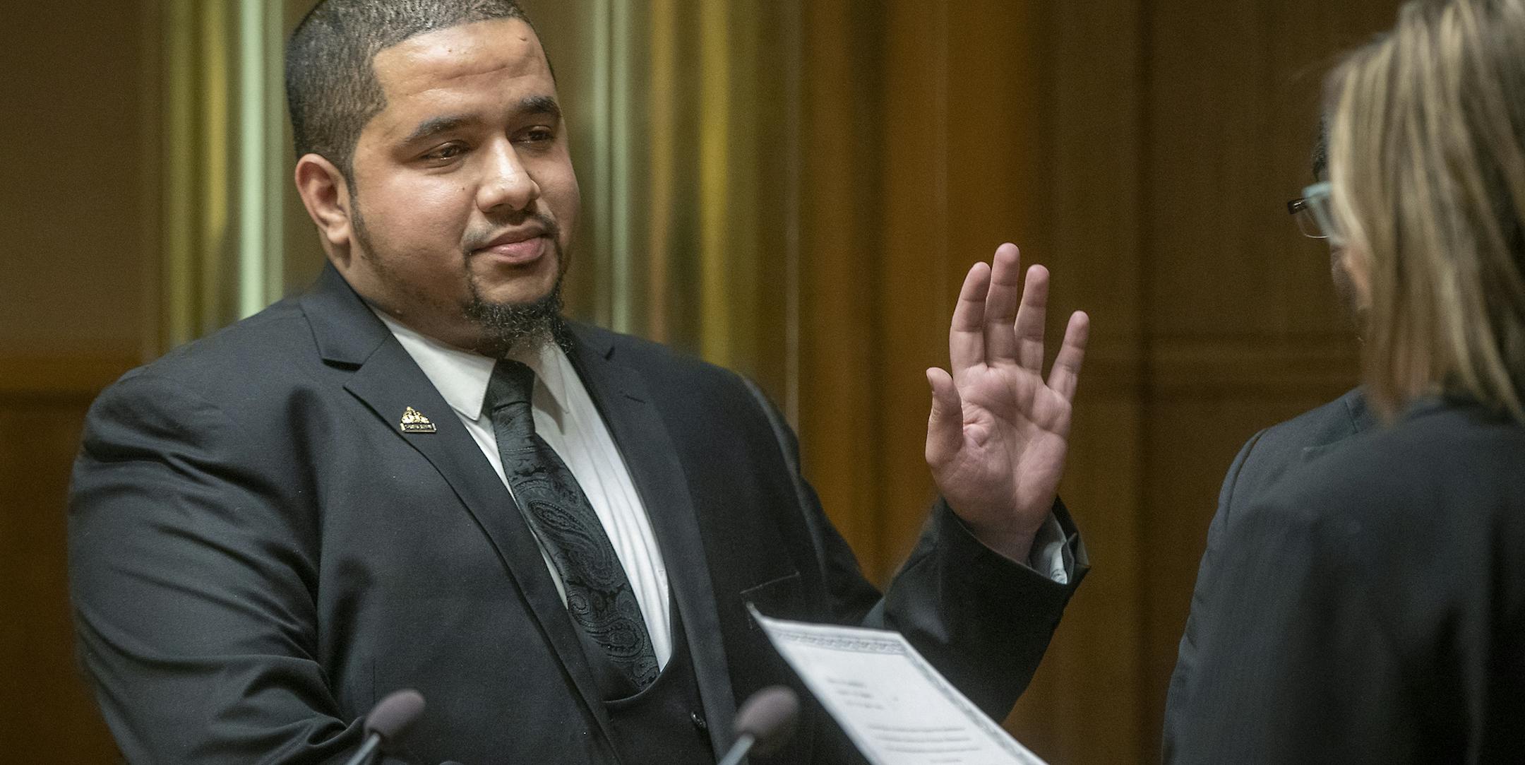 City Council Member Kassim Busuri, left, was sworn in by City Clerk Shari Moore at St. Paul City Hall, Wednesday, February 6, 2019 in St. Paul, MN. Busuri, a local educator, is the first Somali-American to serve on the St. Paul City Council. ] ELIZABETH FLORES • liz.flores@startribune.com
