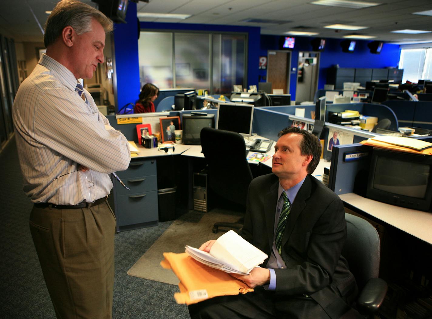 Tom Lyden, a Fox 9 News report, talks with evening anchor Jeff Passolt about a possible story idea sent to Passolt by a prison inmate. Lyden was going to look into the man's situation.