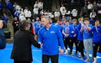 Simley coach Will Short, his team behind him, accepted his medal after the program's sixth state championship in a row.
